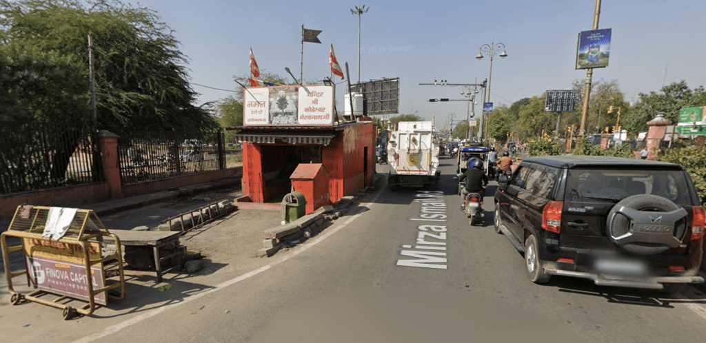 temple in the middle of a road in India Jaipur traffic flowing around shrine