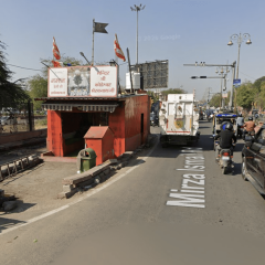 temple in the middle of a road in India Jaipur traffic flowing around shrine